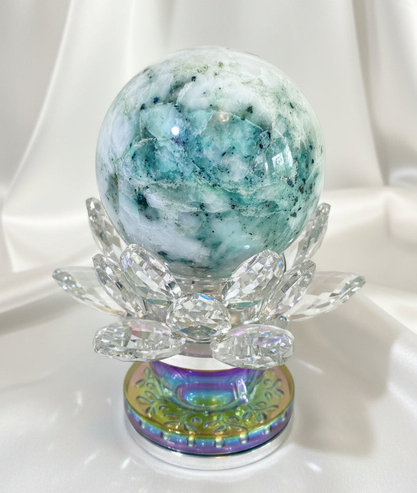 chrysocolla in quartz sphere greens blues and white in a crystal lotus stand 