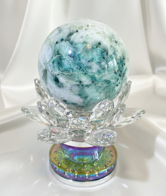 chrysocolla in quartz sphere greens blues and white in a crystal lotus stand 