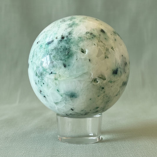 close up showing conchoidal fractures chrysocolla sphere with ocean blue colors and white also druzy pockets 
