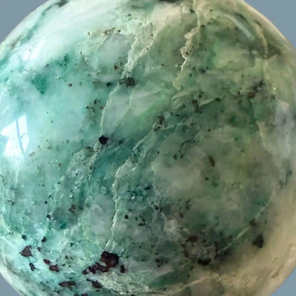 close-up chrysocolla in quartz spahere beautiful blues, teals, dark blues white quartz