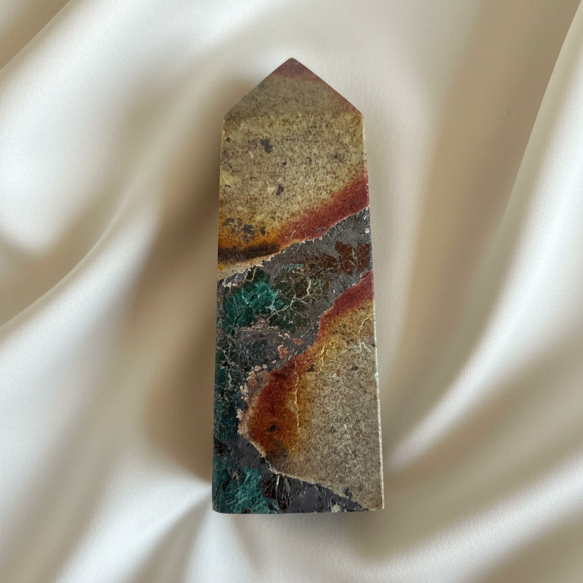 close up photo chrysocolla tower on a white background