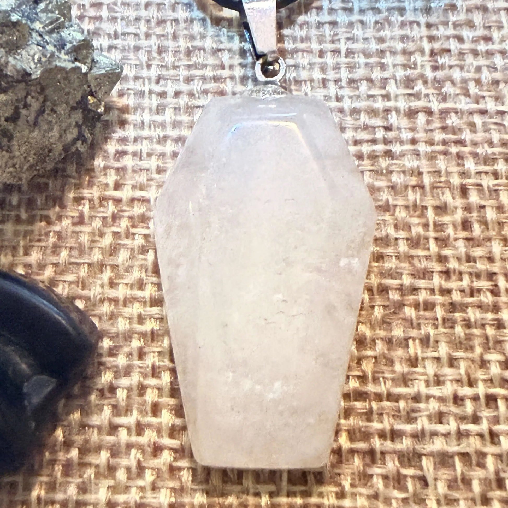 front view photo of clear quartz coffin shaped pendant and alloy citrine bat ring