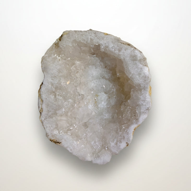 Clear Quartz geode half side view with natural outer matrix