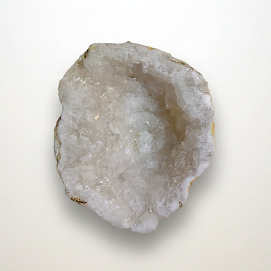 Clear Quartz geode half side view with natural outer matrix