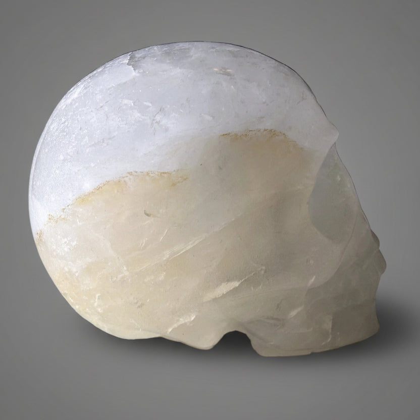 clear quartz hand carved skull with golden healer 
