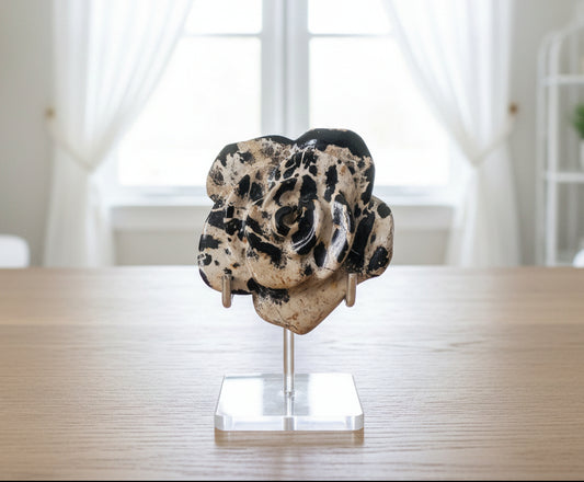 close up dendritic agate carved flower in a premium stand 
