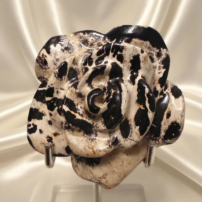 close up of dendritic jasper carved flower warm brown, soft tones sand colors