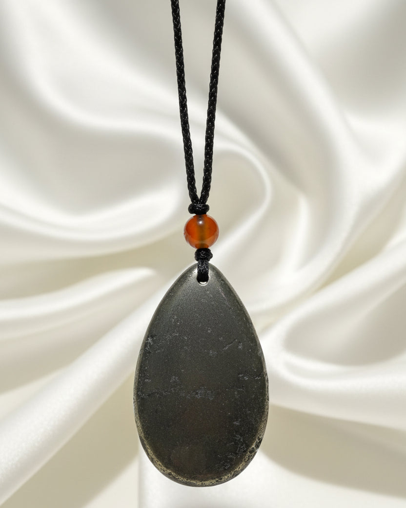 A teardrop-shaped hematite pendant on an adjustable cord with carnelian bead 8 mm