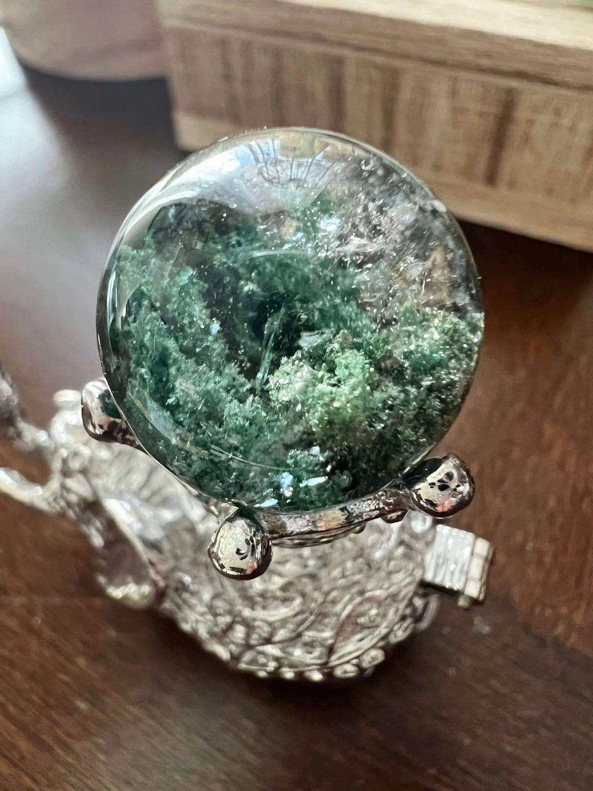 Close-up of a crystal ball on a silver stand.