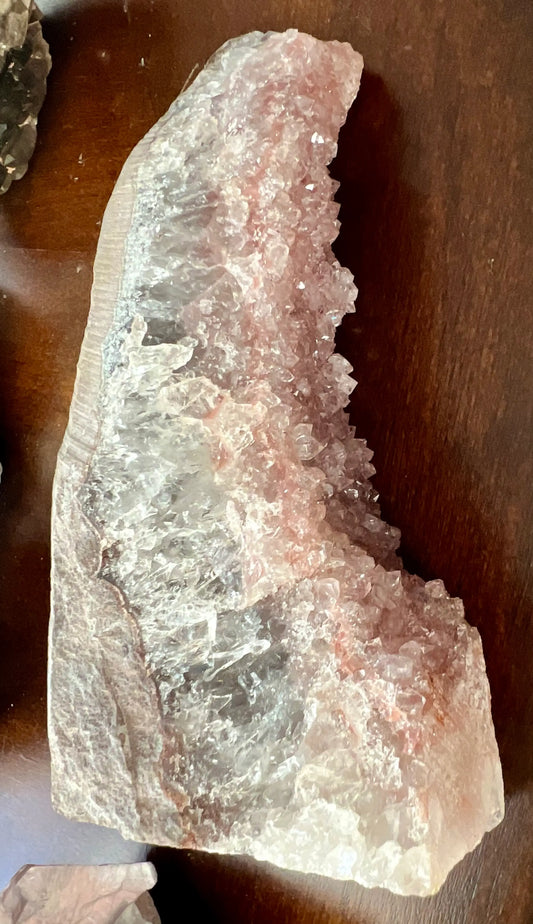 Pink Amethyst crystal cluster specimen on wooden surface
