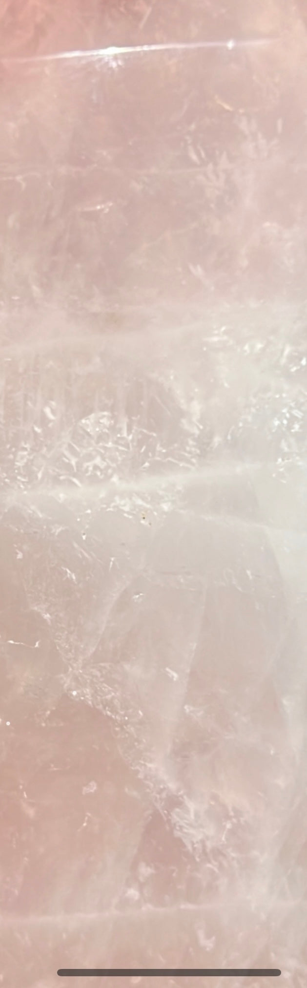 Close-up of a pale pink rose quartz crystal.