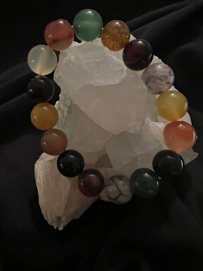 Multicolor dyed Agate bracelet displayed on crystal