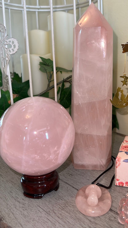 Rose quartz crystal sphere, tower, and pendant.