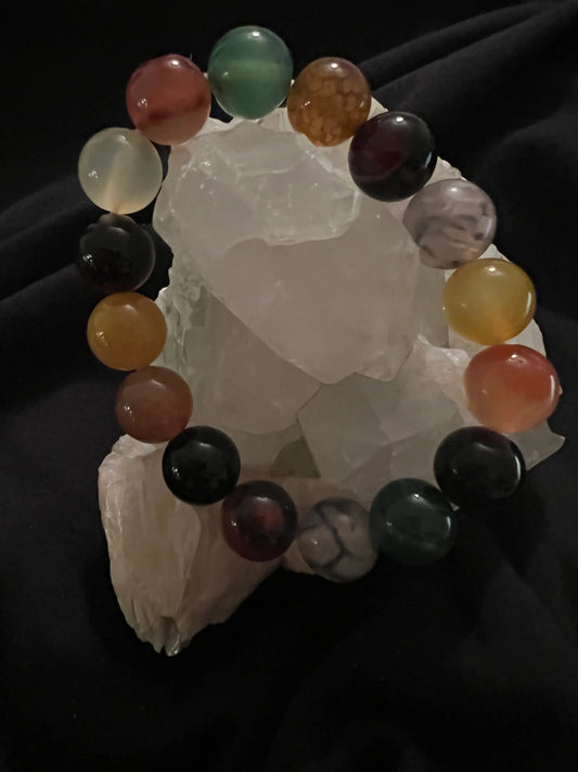 Multicolor dyed Agate bracelet displayed on crystal