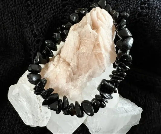 Black Obsidian crystal chip bracelet on white rock