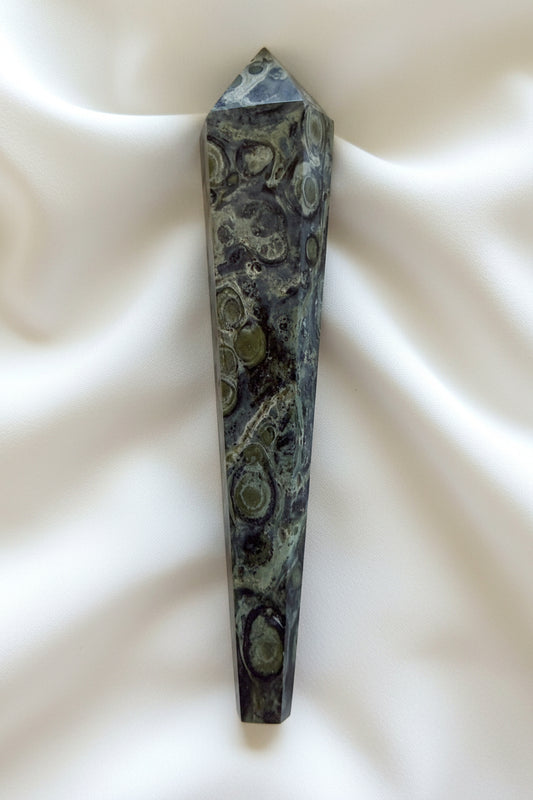 side view of a kambaba jasper wand beautiful hues of greens and back swirls throughout 