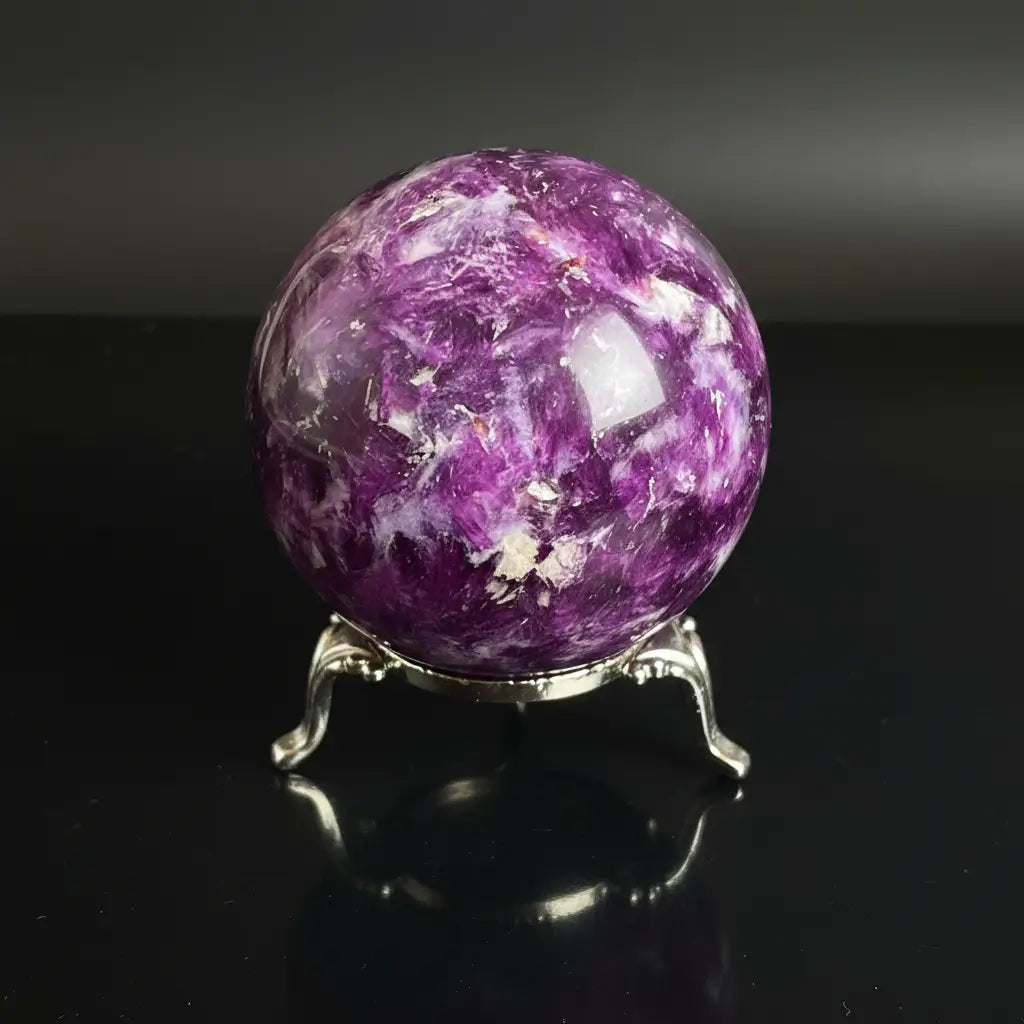 close up of lepidolite sphere showing mica and dark purples 