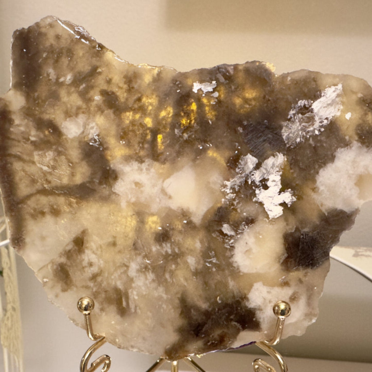 beautiful golds, tans and muscovite shimmer slab in an easel stand