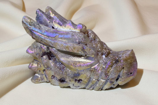 beautiful photo close up of rainbow aura carved dragon skull beautiful colors and bright druzy pockets