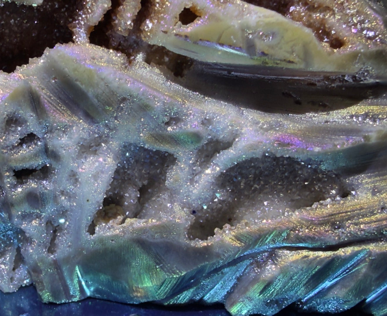 beautiful close up of the glittery pockets  rainbow aura sphalerite purples green 