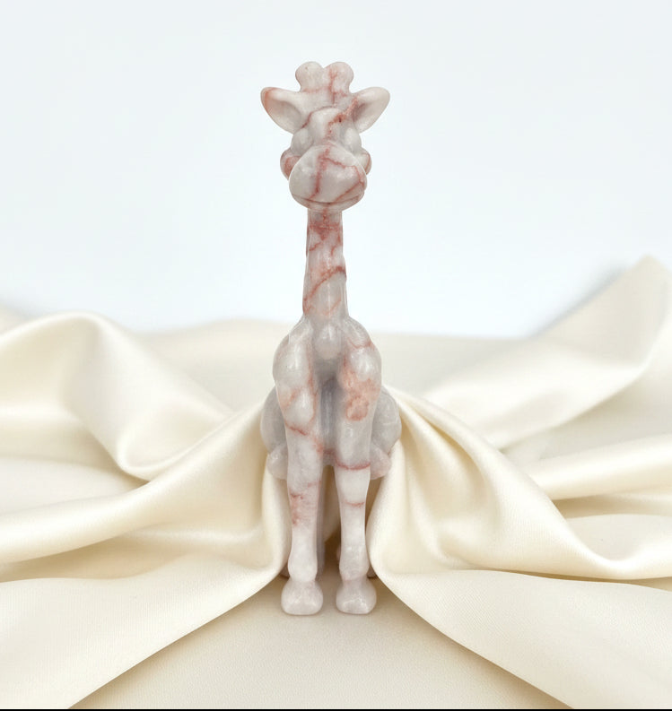 close up of giraffe hand carved from red vein jasper crystal  cute smiling face, ears and facial features 