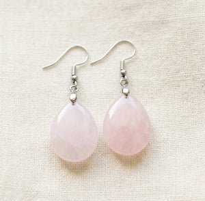 pink rose quartz tear drop earrings close up photo