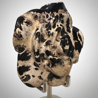 Side view close up dendritic jasper carved flower in a stand 