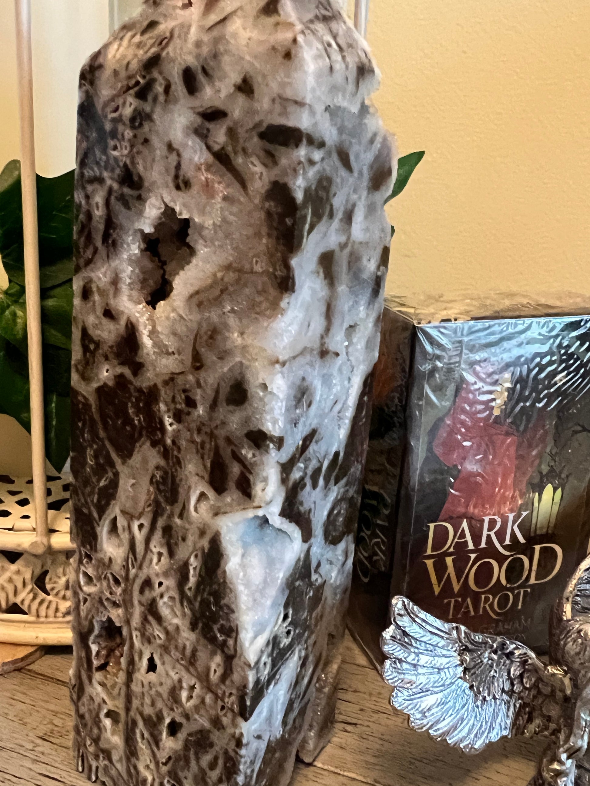 Tall geode tower, "Dark Wood Tarot" deck, and silver angel wing decoration.