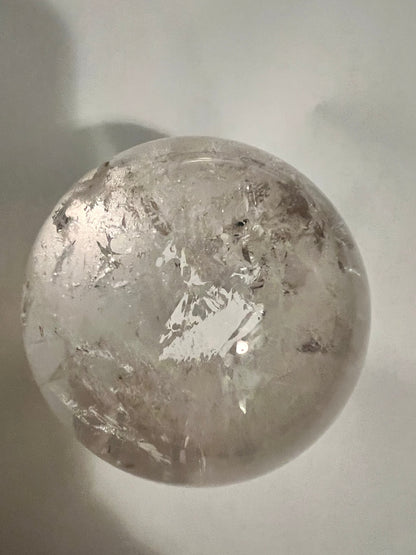 Clear crystal sphere with internal cracks.
