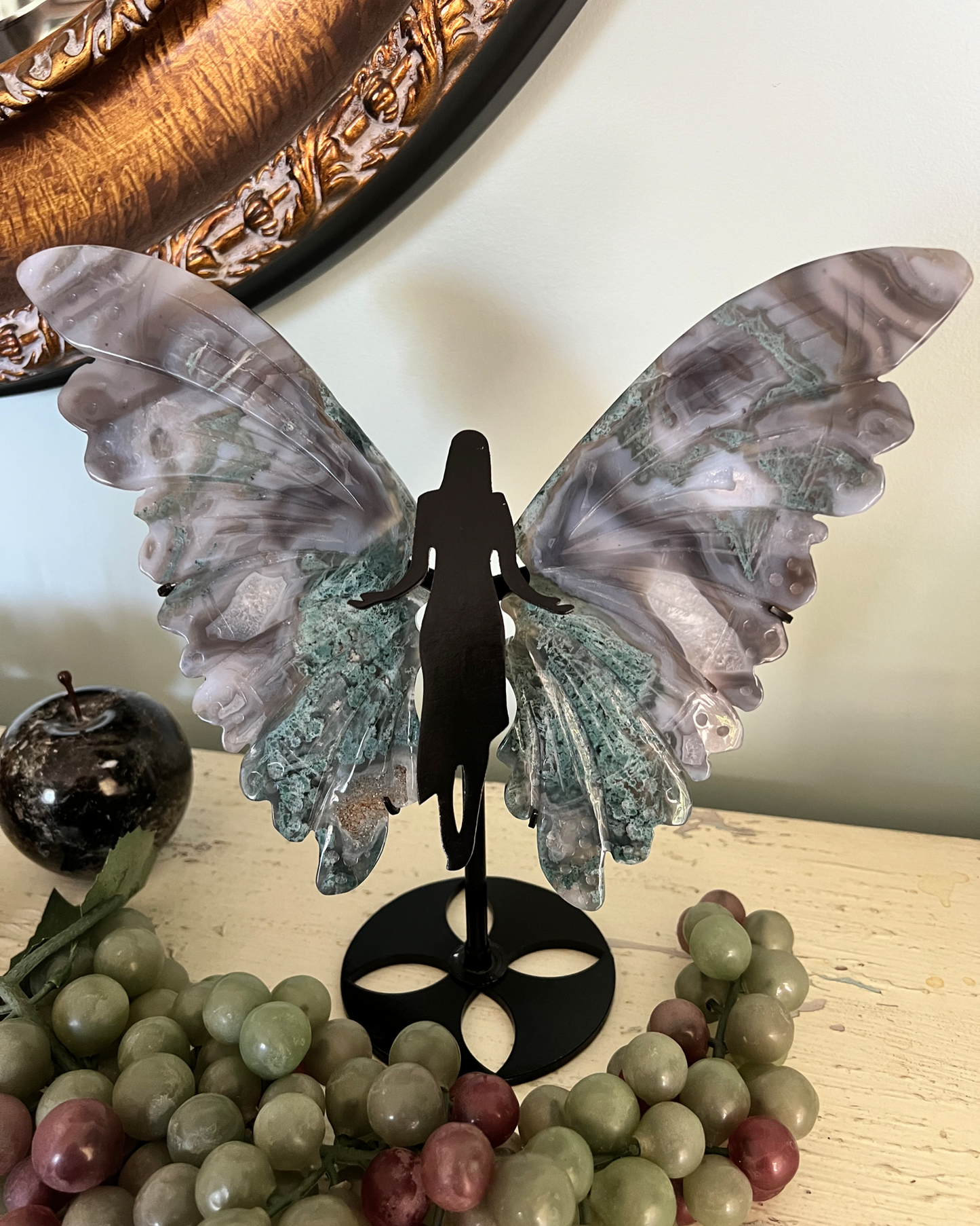 Green Moss Agate druzy wing sculpture among stone fruit