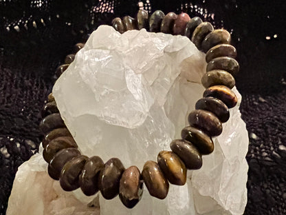 Brown beaded bracelet on a white crystal. 
