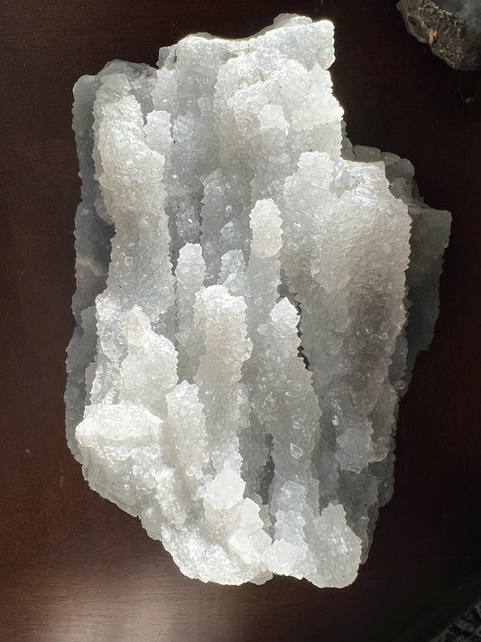White crystal formation on dark surface.