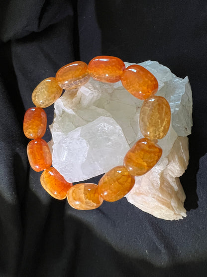 Orange agate beaded bracelet on rough crystal.