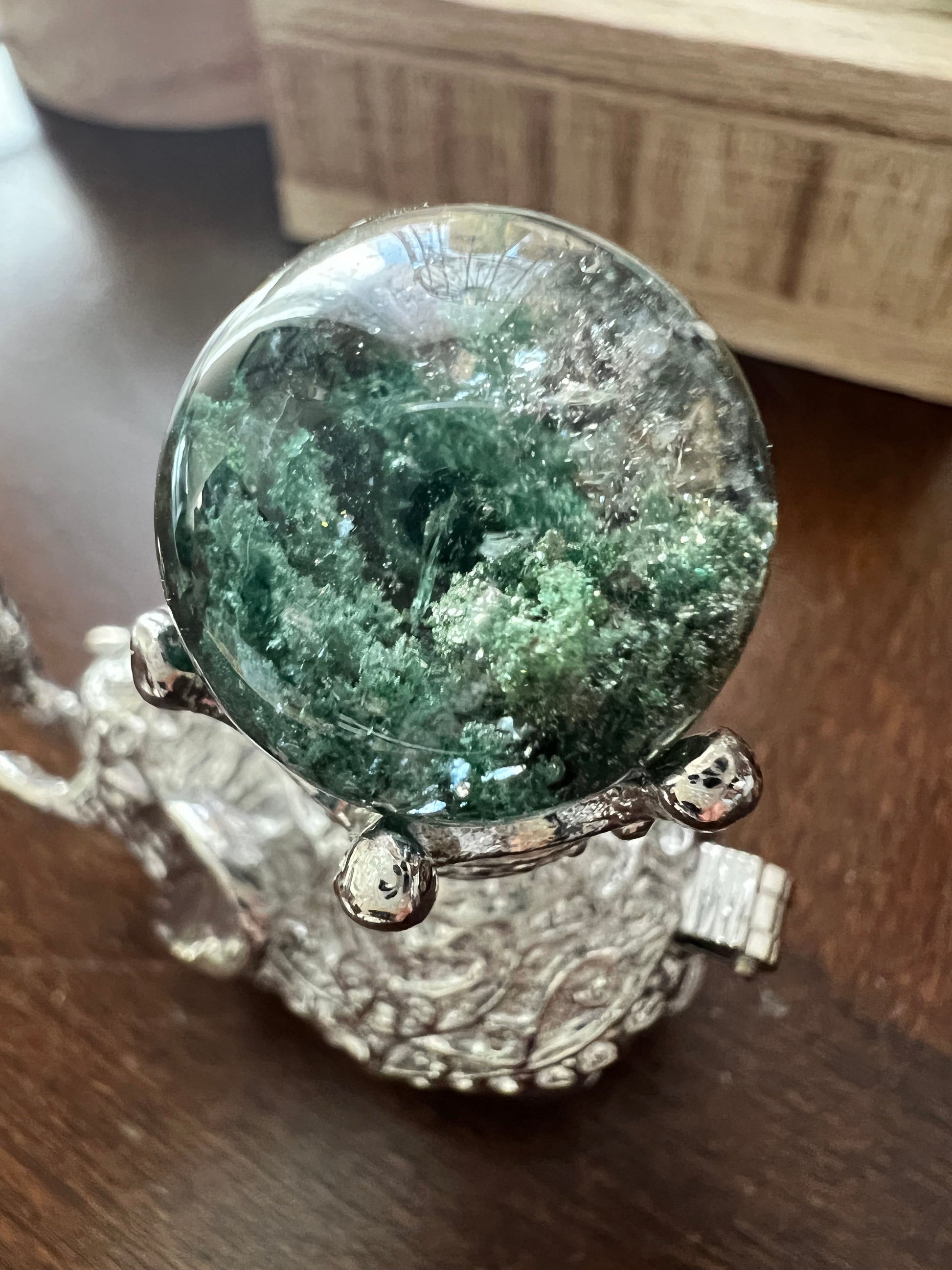 Close-up of a crystal ball on a silver stand.