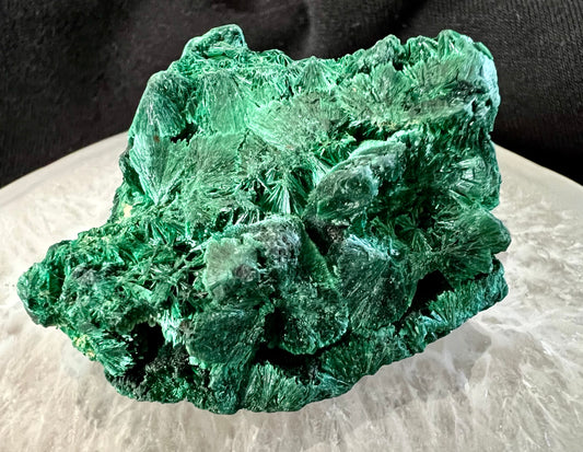 Close-up of a bright green, crystalline malachite mineral specimen.